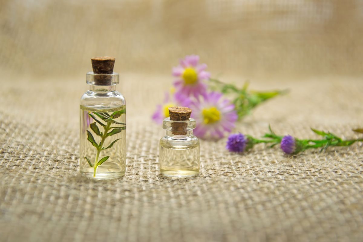 Essential oil bottles with fresh flowers